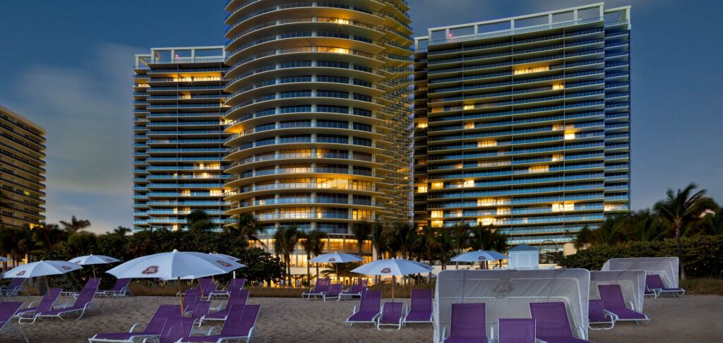 Beach chairs on the sand in front of St. Regis exterior