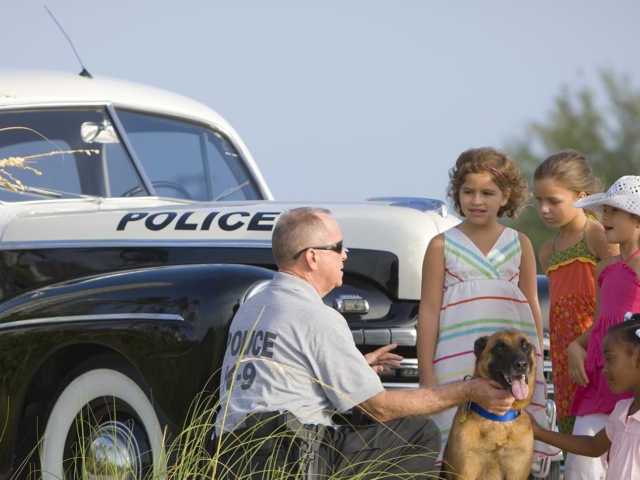 A police officer talks to children