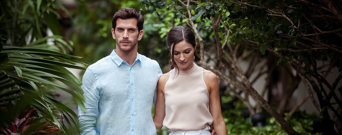 A couple walking in a garden setting