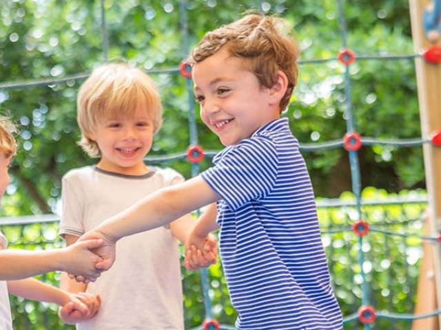 Three kids play on the playground