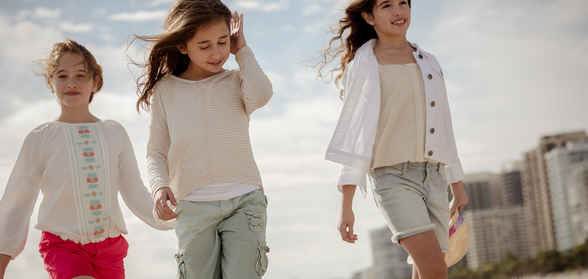 Kids walk down the beach