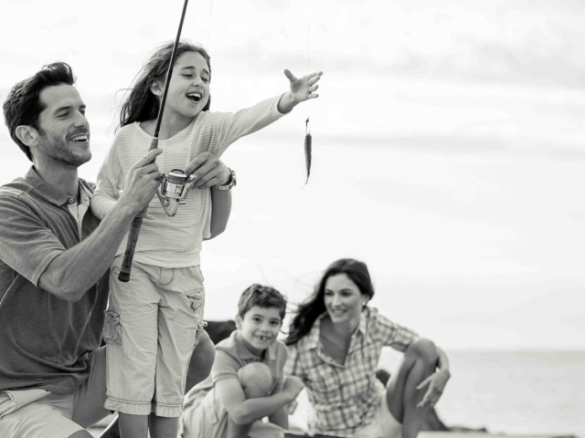 A child fishing with her family