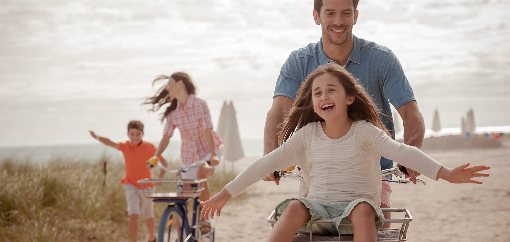 A family biking down the beach