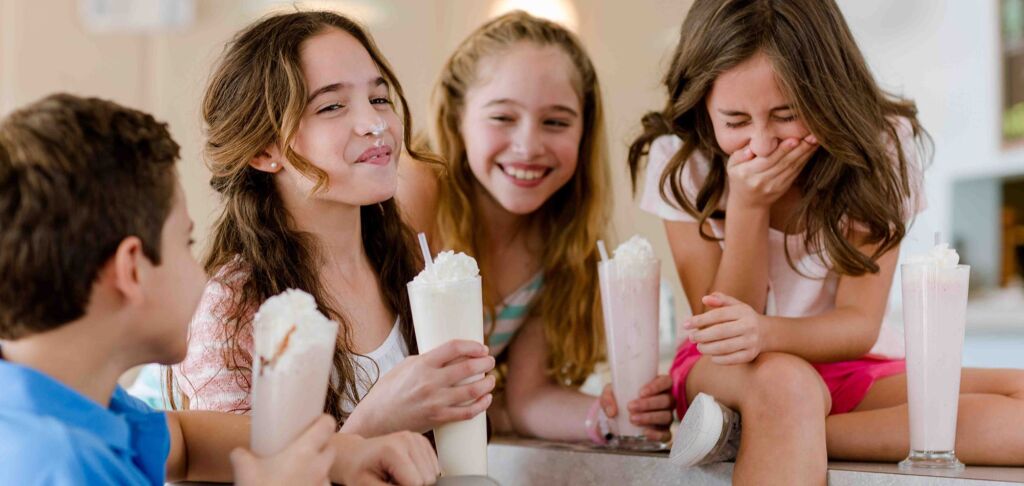 Girls laughing and eating ice cream
