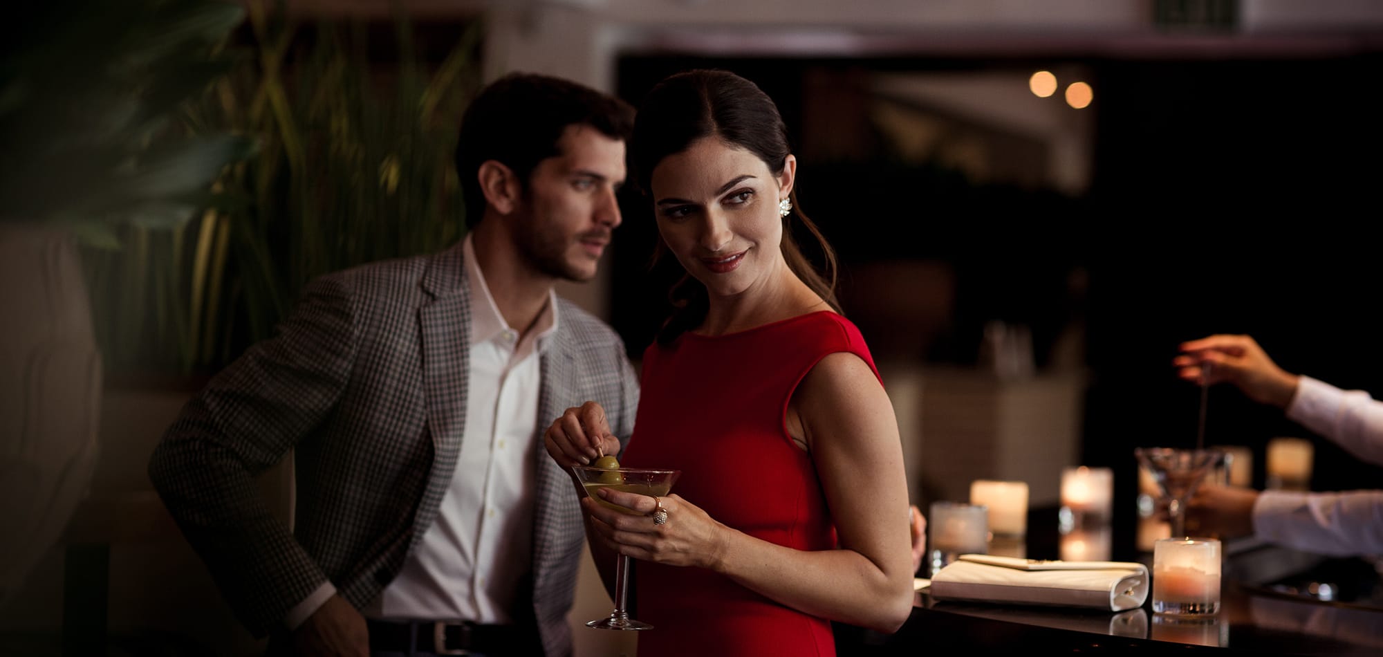 A woman drinks a martini