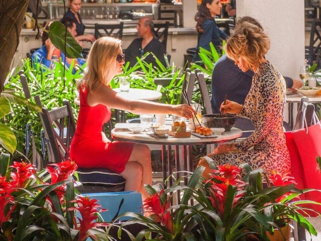 Two women eat lunch outside