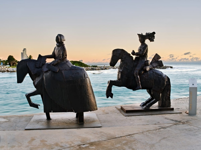 Sculptures of horses by the beach