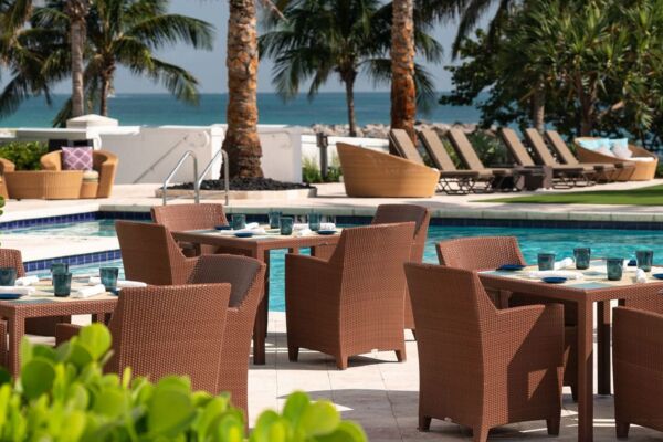 Tables and chairs by the pool