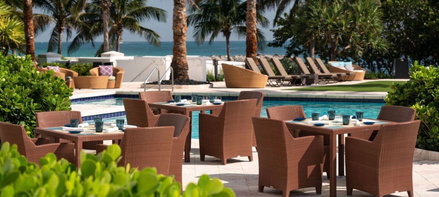 Tables and chairs by the pool