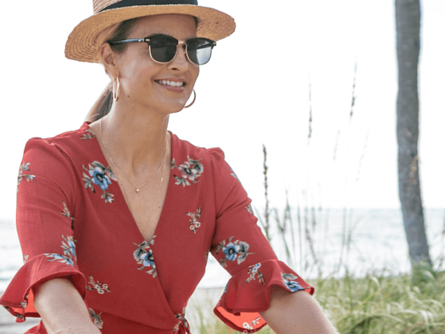 A woman rides a bike on a sunny day