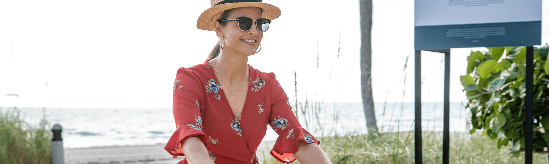 A woman rides a bike on a sunny day