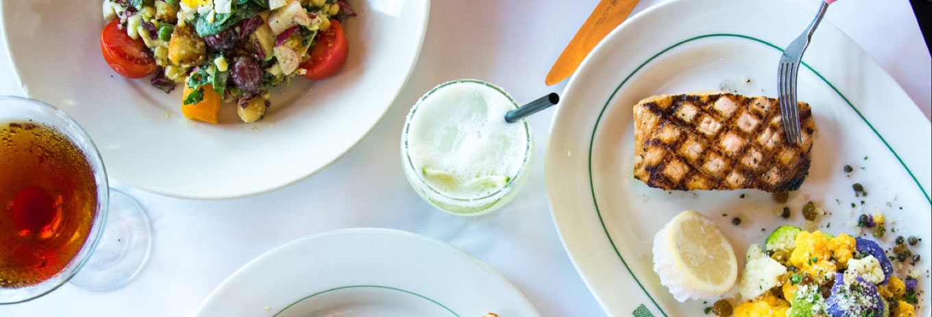 Fish and other dishes on a white tablecloth