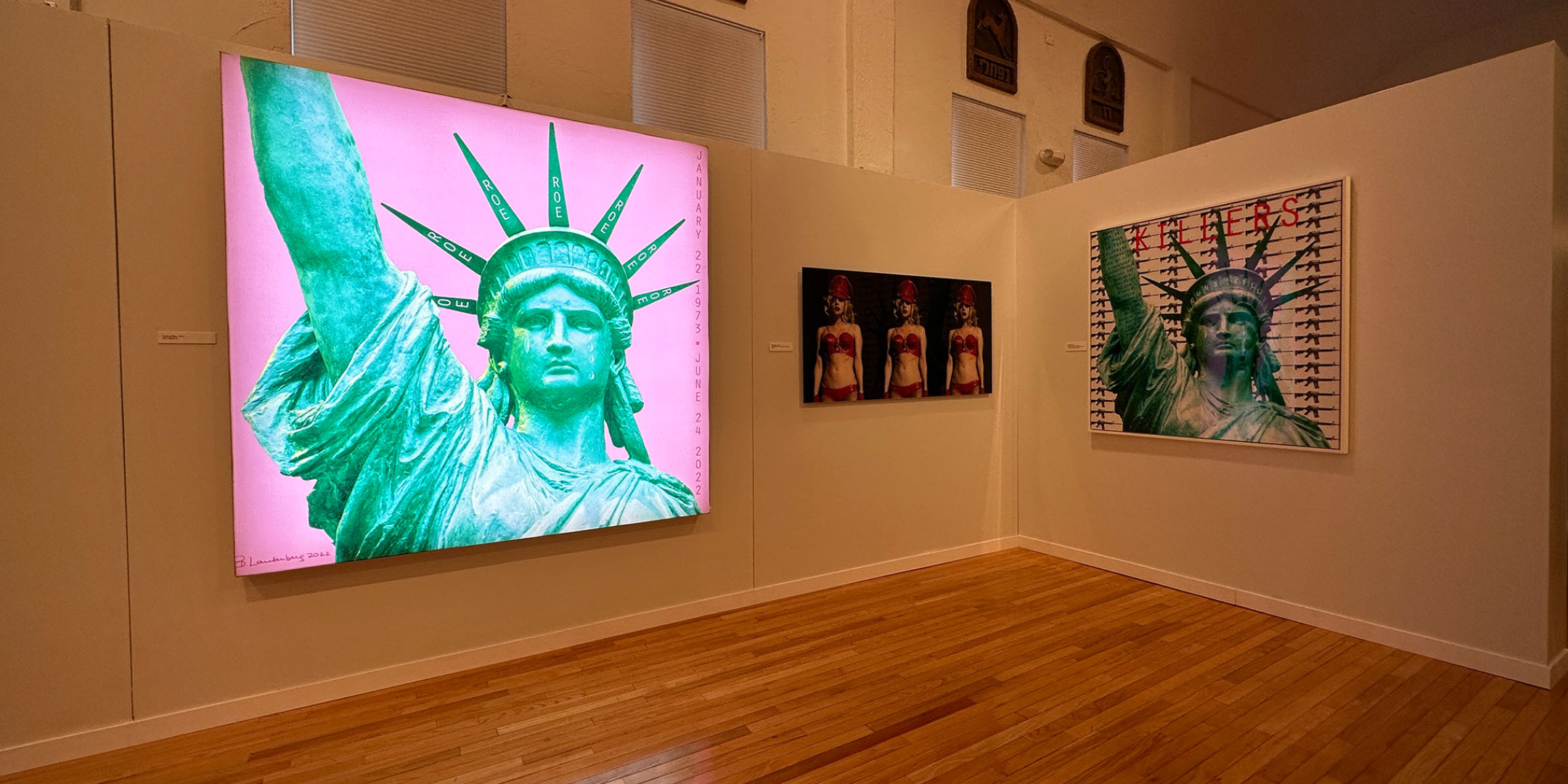 Image of Statue of Liberty on Museum Wall, along with two other art works.